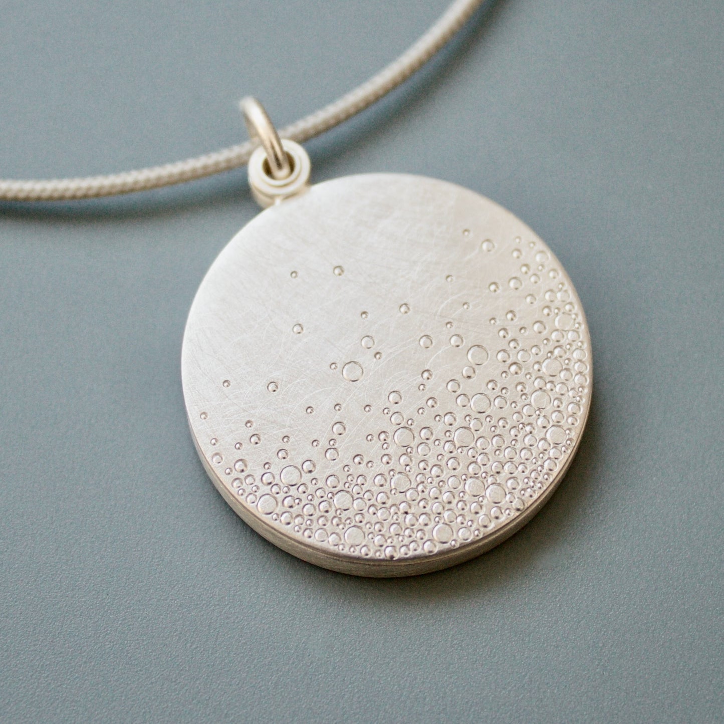 modern photo locket in sterling silver with bubbles design