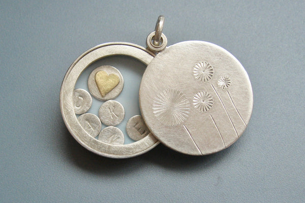sterling silver floating dandelion locket filled with stamped letter plates