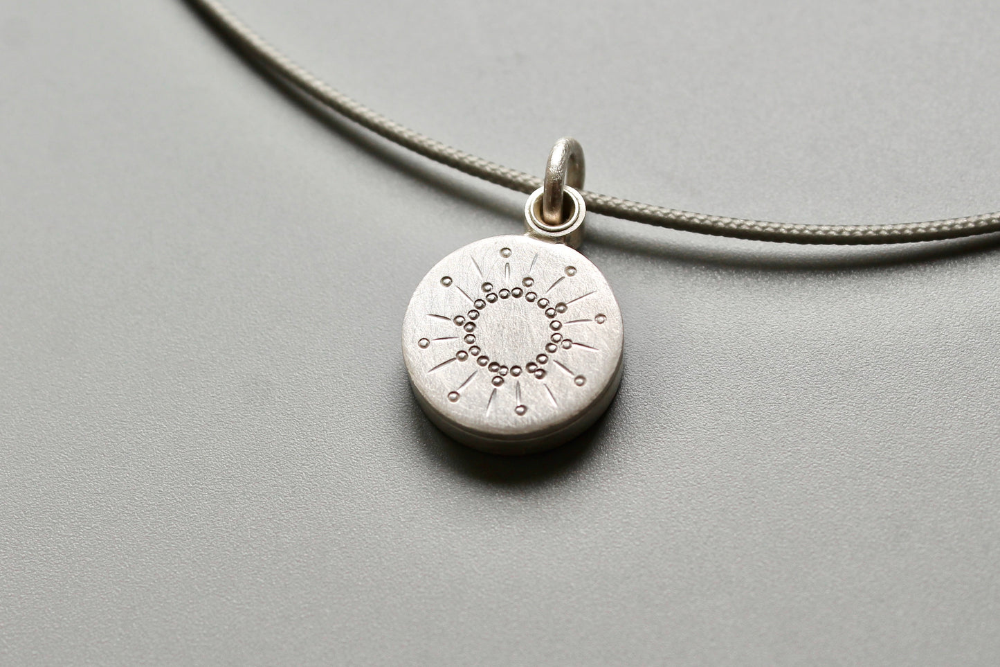 tiny silver picture locket with sun design