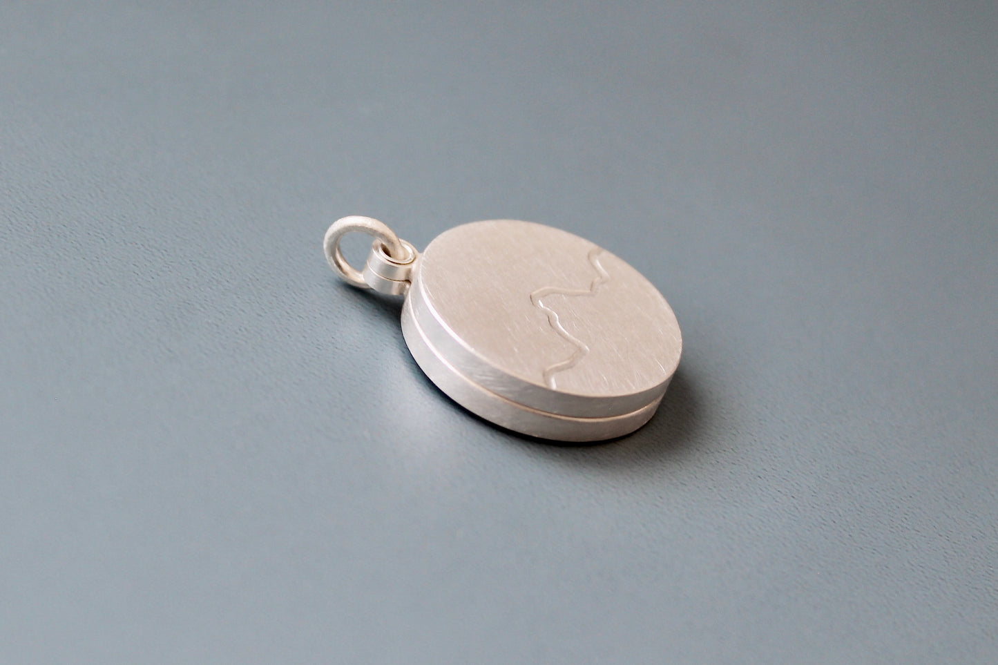 minimalist photo locket with mountain range in sterling silver