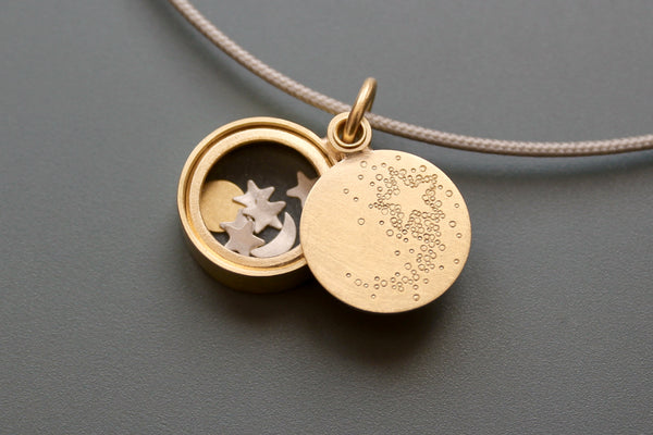 golden floating locket with shooting star