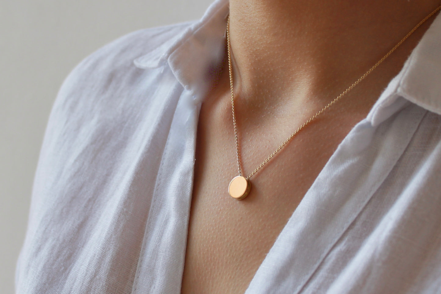 tiny minimalist necklace in 18ct gold with reversible check pattern pendant