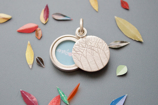 minimalistic silver locket for a small picture forest design