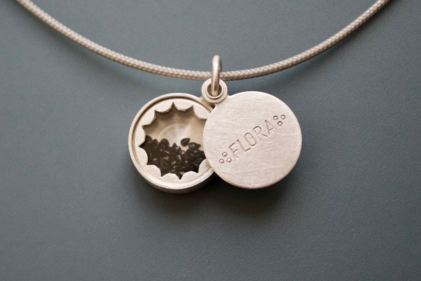 silver floating locket with custom name with forget me not seeds