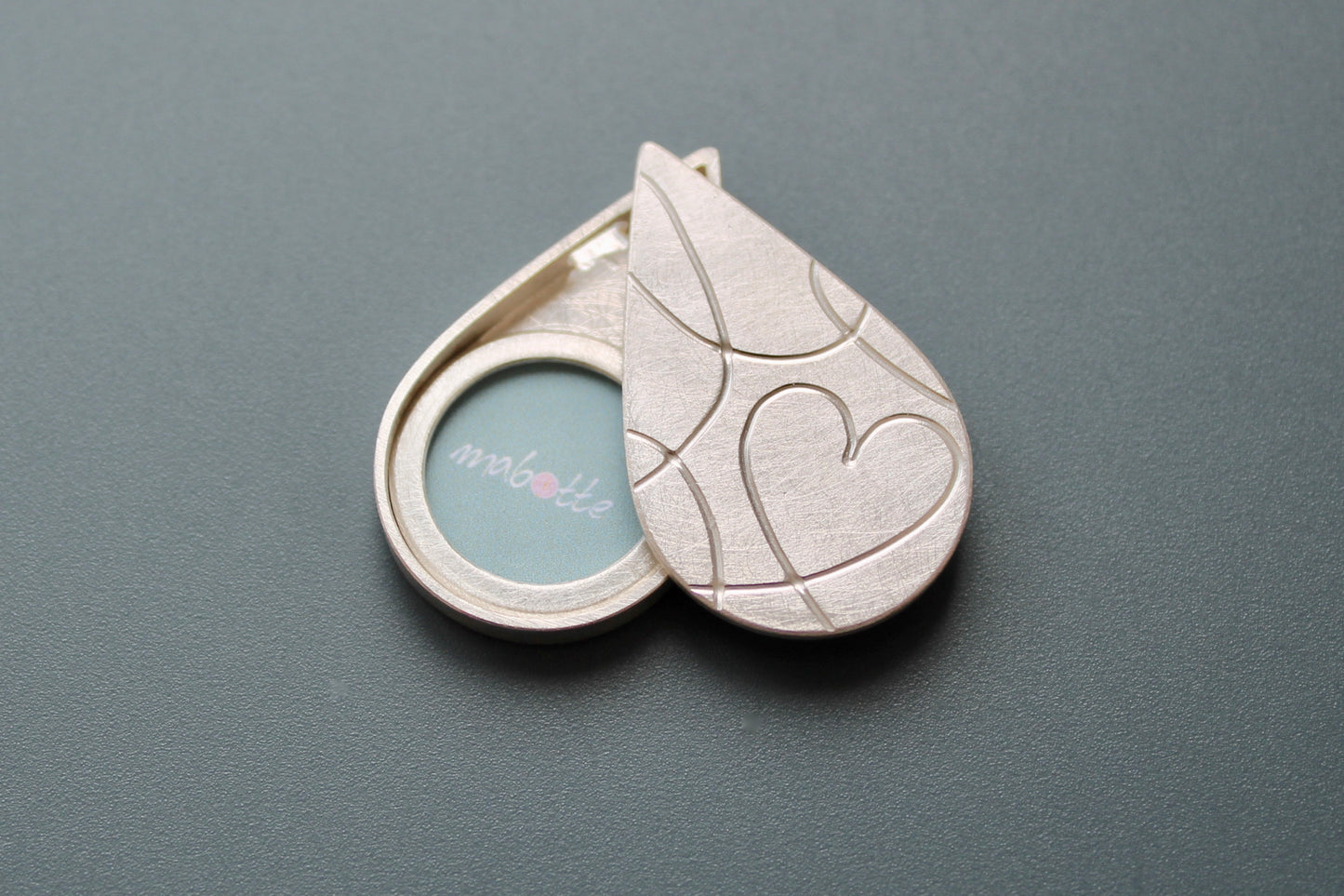 silver drop shaped picture locket with elegant heart design