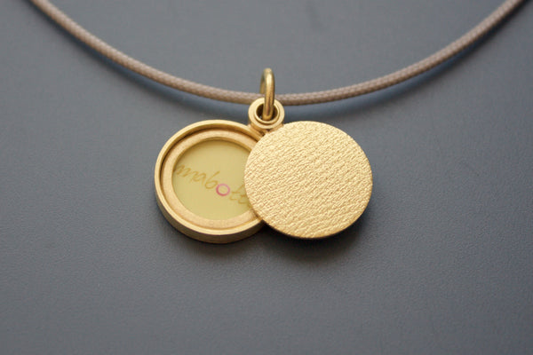minimalist modern locket for a small photo in 18ct yellow gold