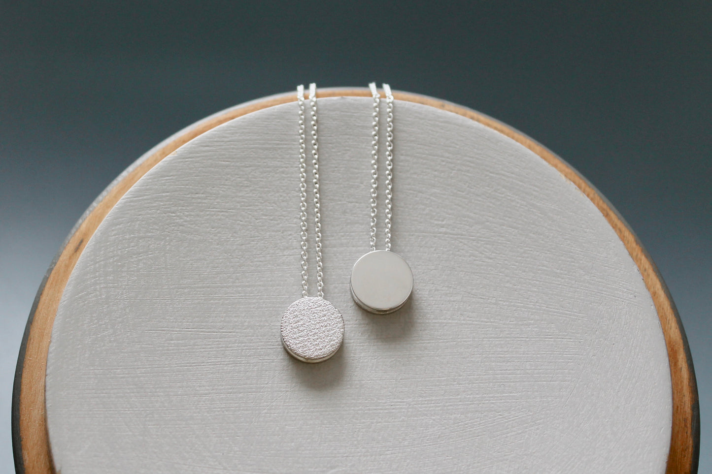 tiny round necklace in sterling silver with textured surface