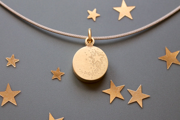 golden floating locket with shooting star