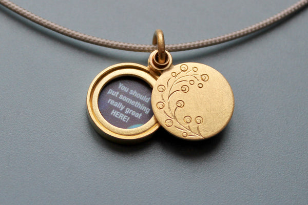 small floral picture locket in 18ct gold with twig