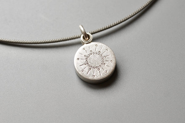 tiny silver picture locket with sun design