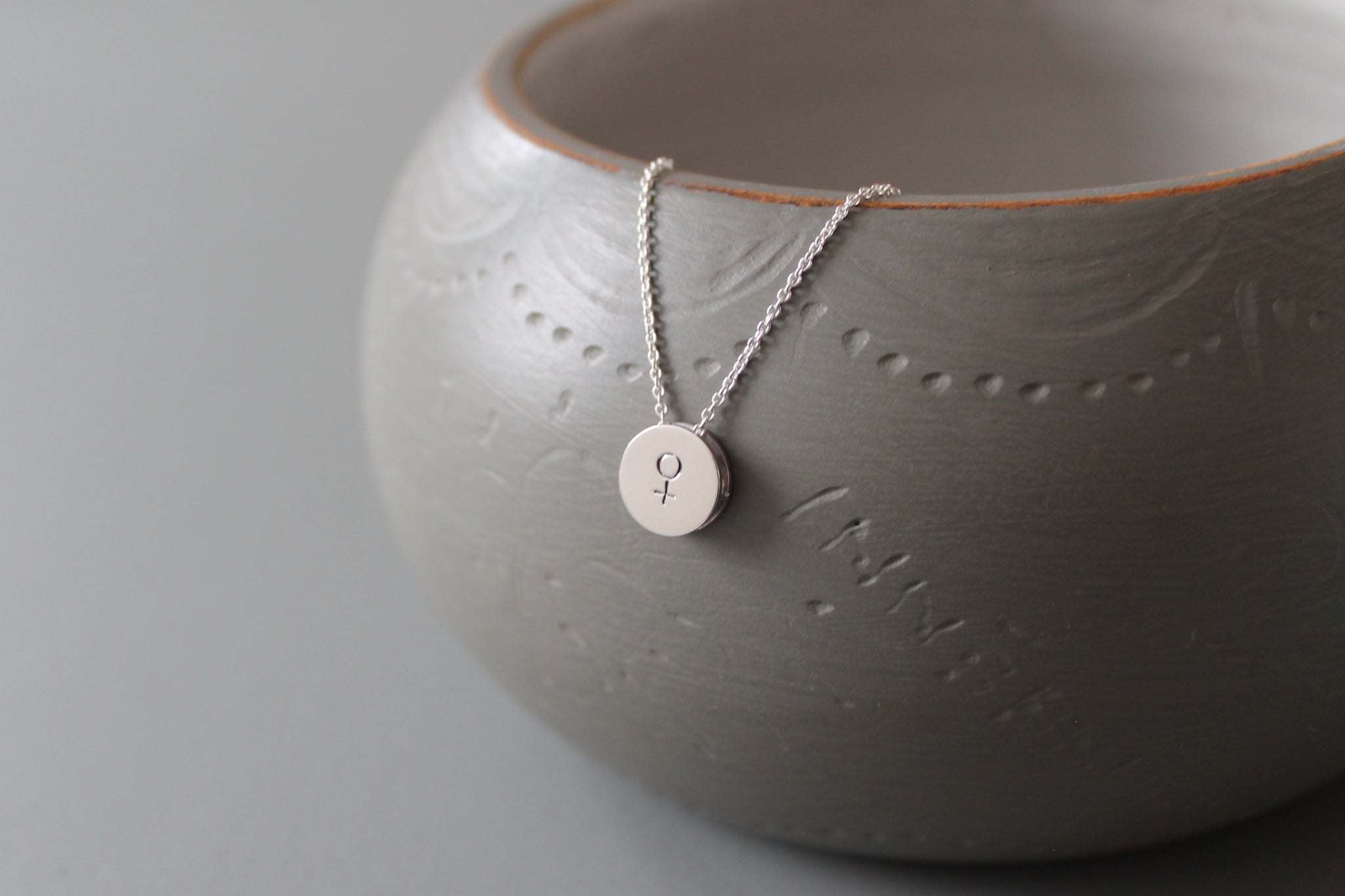 minimalist silver necklace with venus symbol
