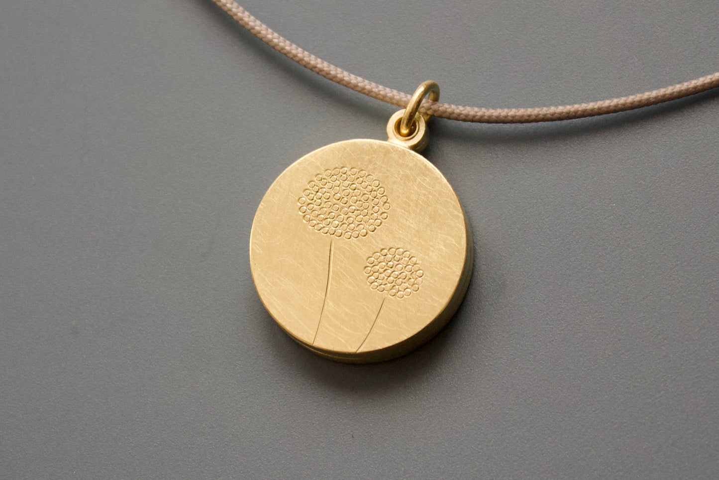 golden double locket with delicate dandelions