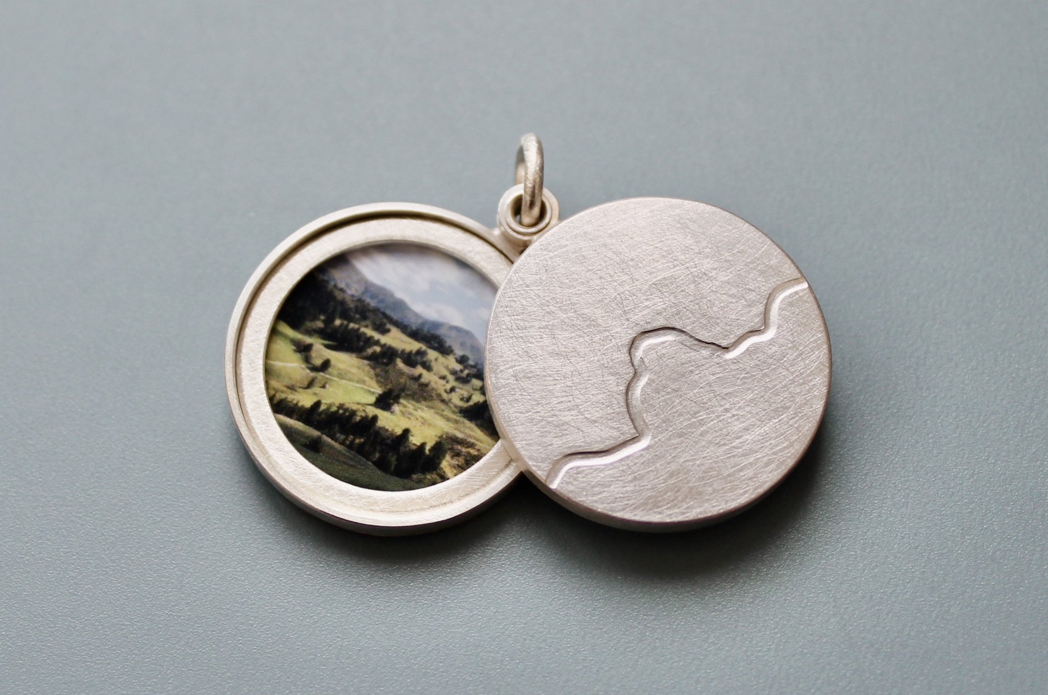 minimalist photo locket with mountain range in sterling silver