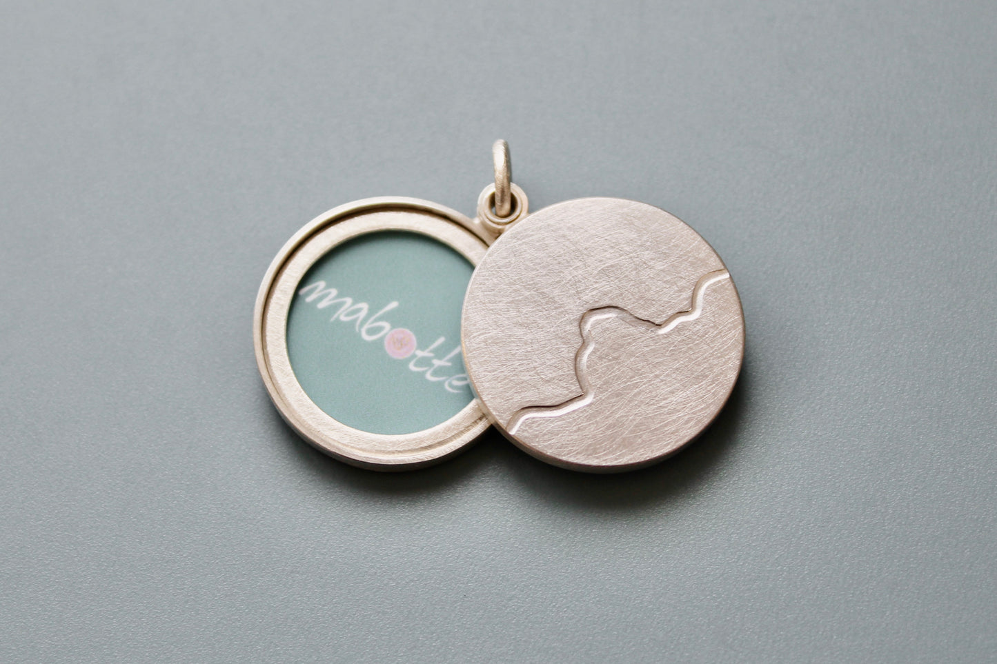 minimalist photo locket with mountain range in sterling silver