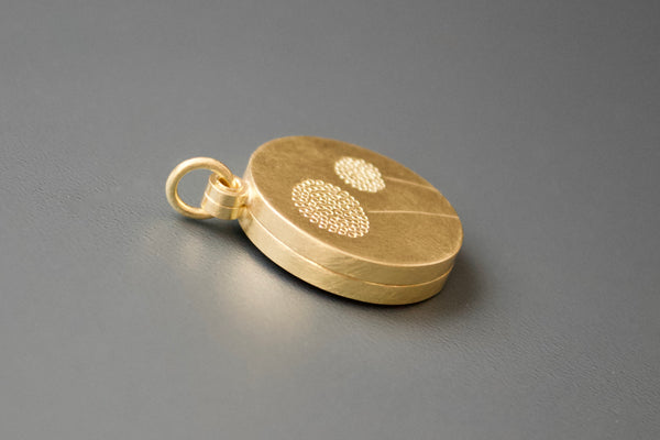 golden double locket with delicate dandelions