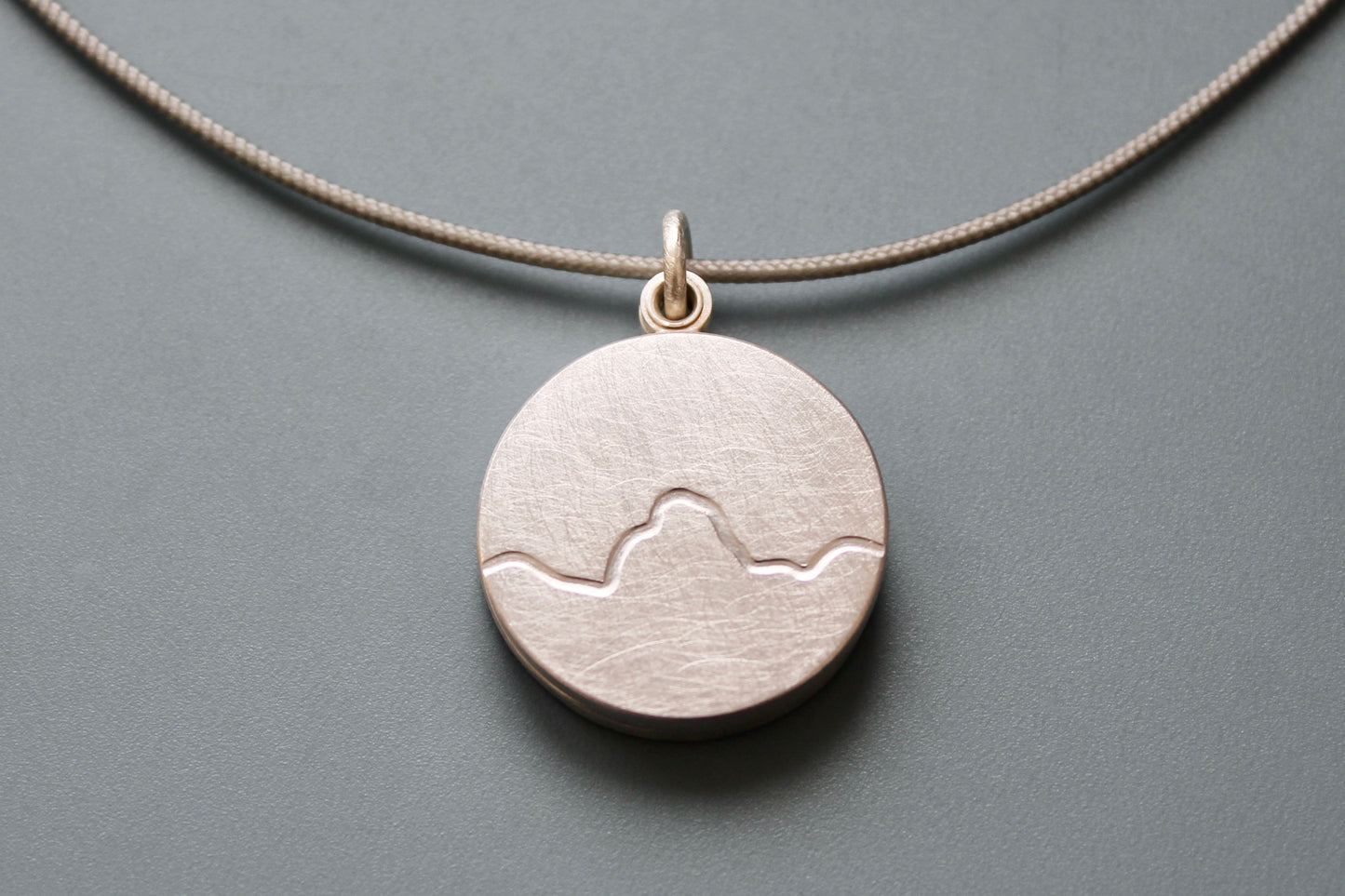 minimalist photo locket with mountain range in sterling silver