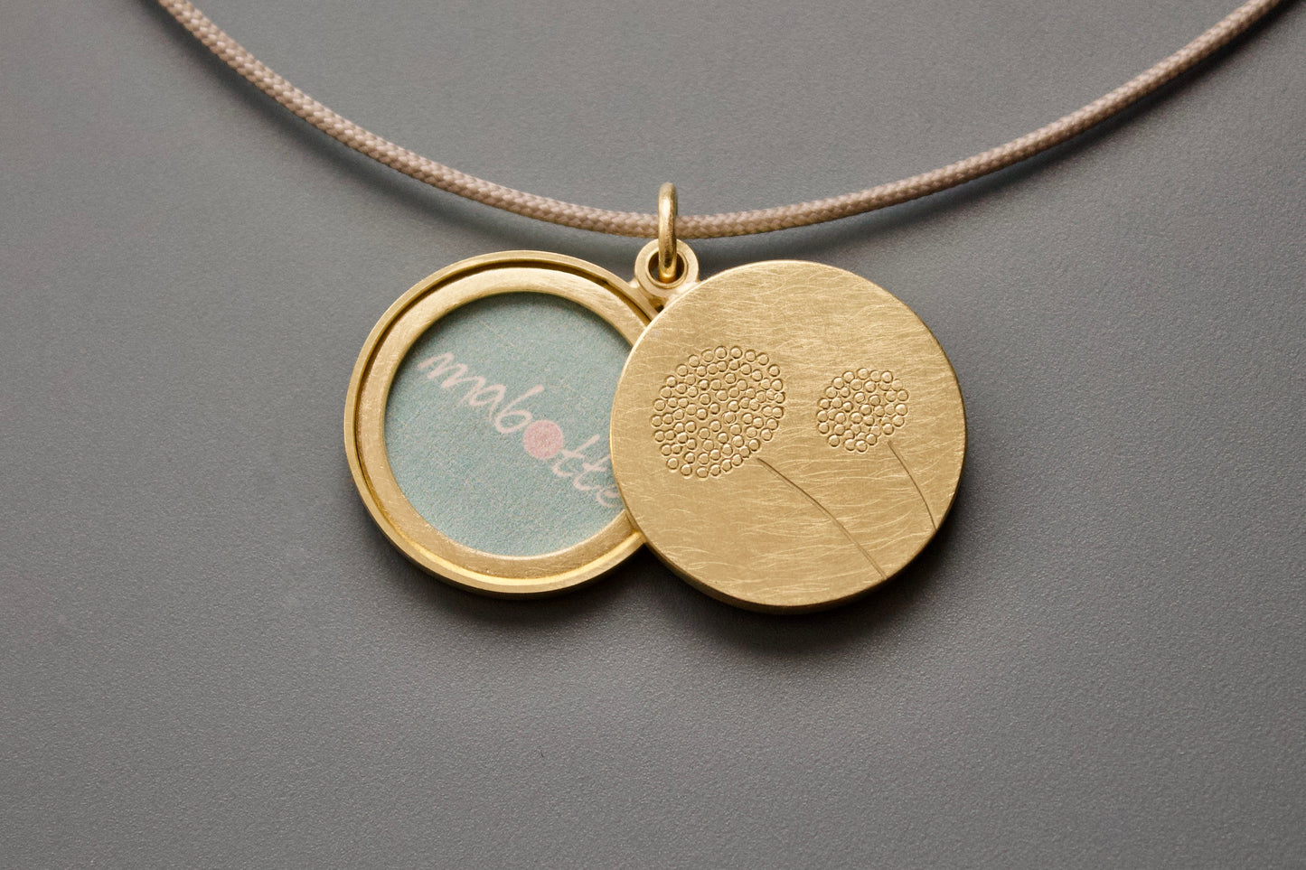 golden double locket with delicate dandelions