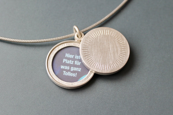 Minimalist silver locket for two pictures with aureole