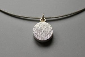 minimalist modern locket for two small photos made from textured sterling silver