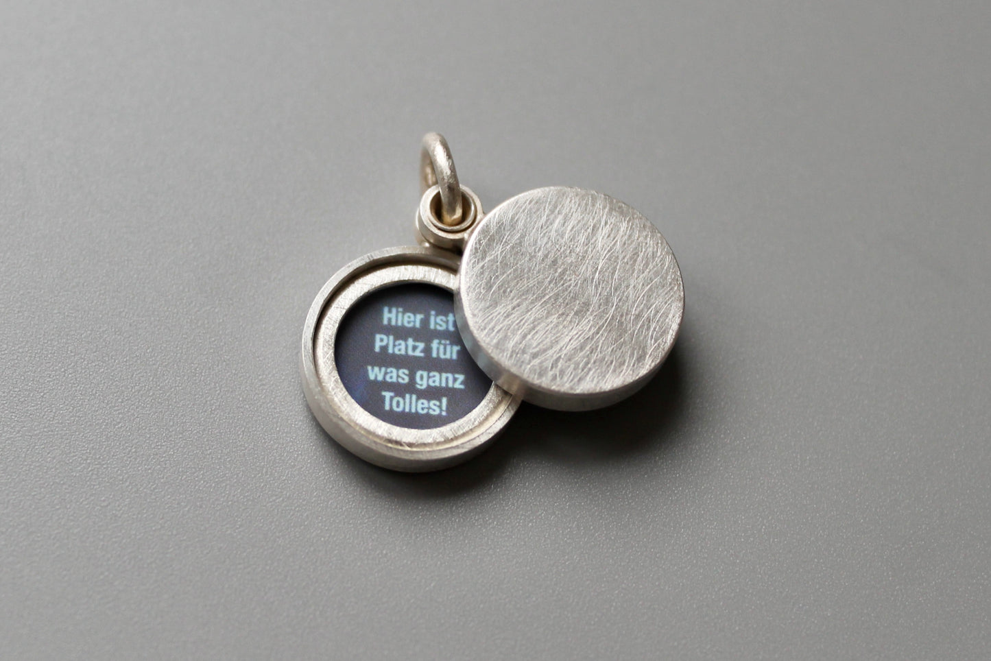 minimalist modern locket for two small photos made from textured sterling silver