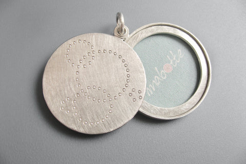 round matt finished picture locket with minimalist design in sterling silver