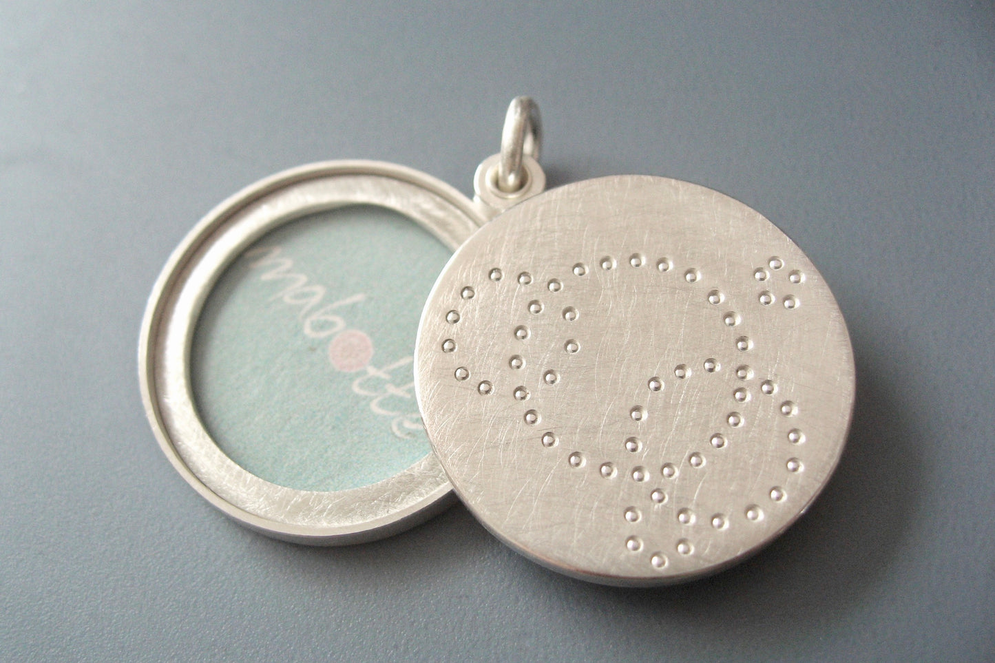 contemporary locket for two pictures handmade in sterling silver