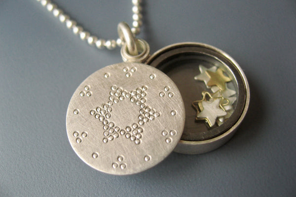 beautiful living locket filled with tiny stars in sterling silver