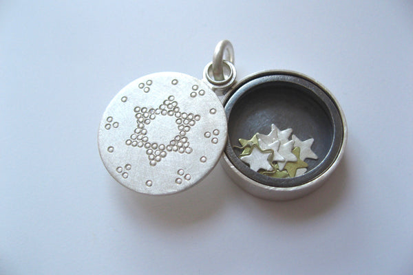 beautiful living locket filled with tiny stars in sterling silver