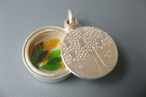 handmade glass locket filled with colorful leaves with family tree design
