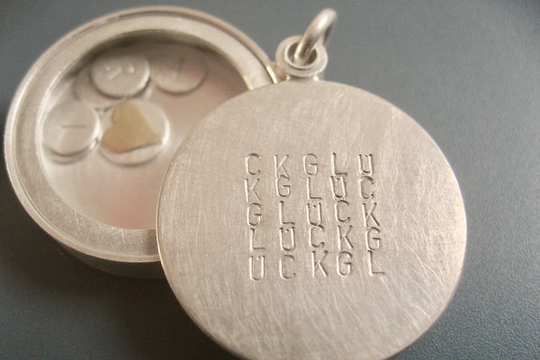 custom glass locket with floating name plates in sterling silver with typographic design