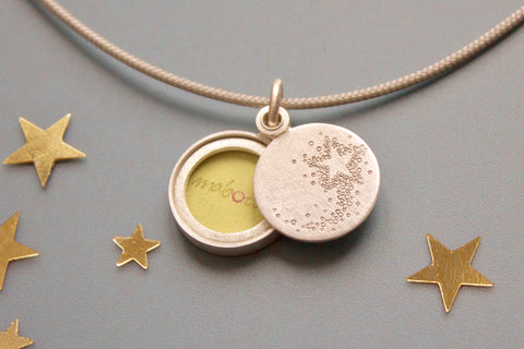 tiny sterling silver photo locket with a shooting star