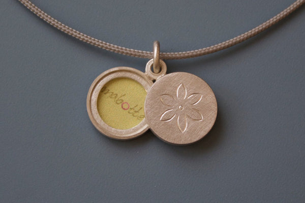 small sterling silver locket for two pictures with dainty flower design
