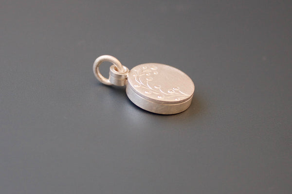 dainty round photo pendant with delicate twig in sterling silver