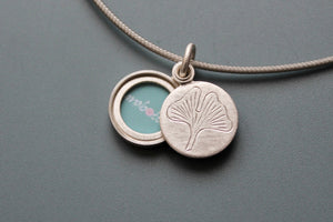 small sterling silver picture locket with gingko leaf