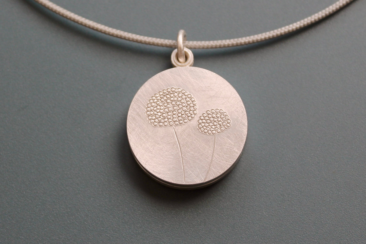 mabotte double locket with delicate dandelions in sterling silver