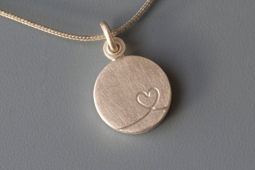 charming silver photo locket with  little heart design