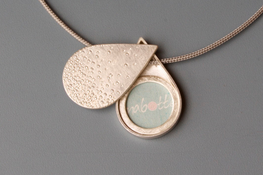 drop shaped secret photo locket in sterling silver with bubbles design