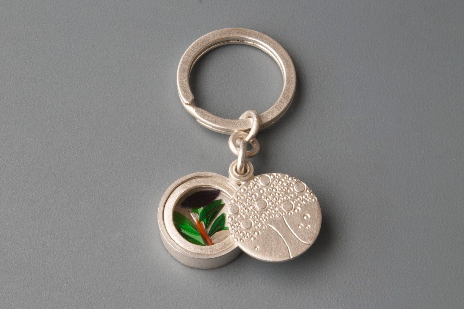 silver keyring glass locket filled with colourful leafs and tree of life