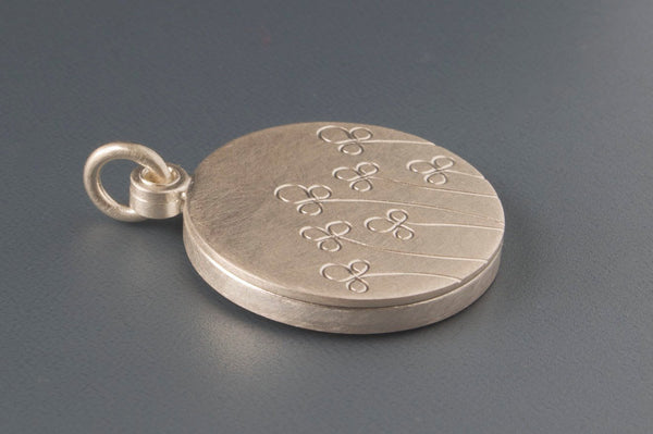 floral picture locket in sterling silver with field of flowers