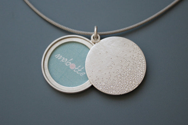 modern photo locket in sterling silver with bubbles design