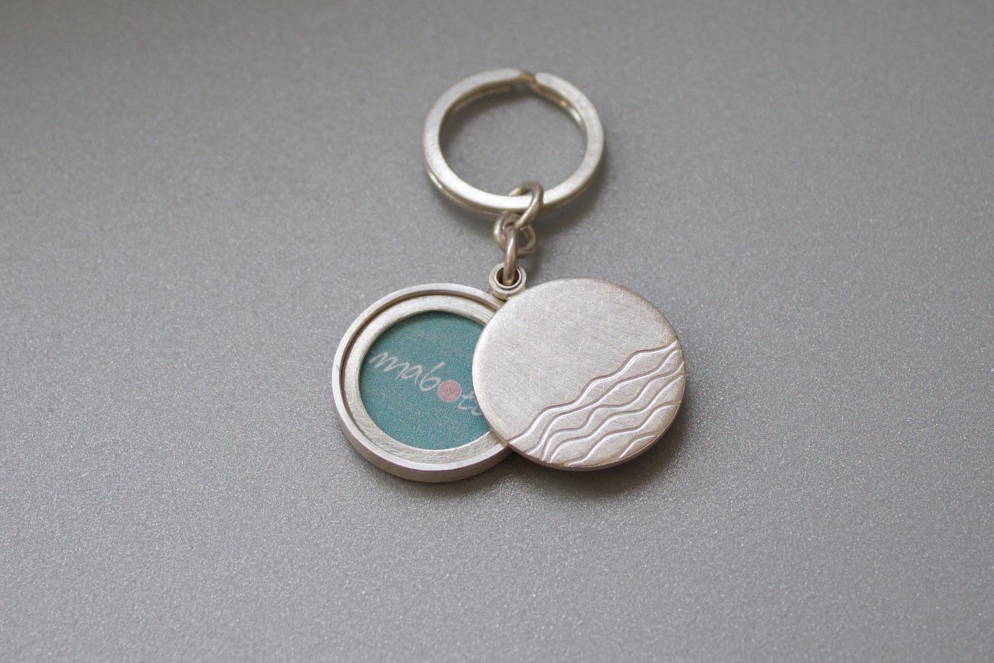 minimalist silver keychain locket with waves for one photo